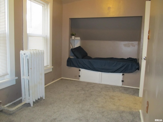 carpeted bedroom featuring radiator