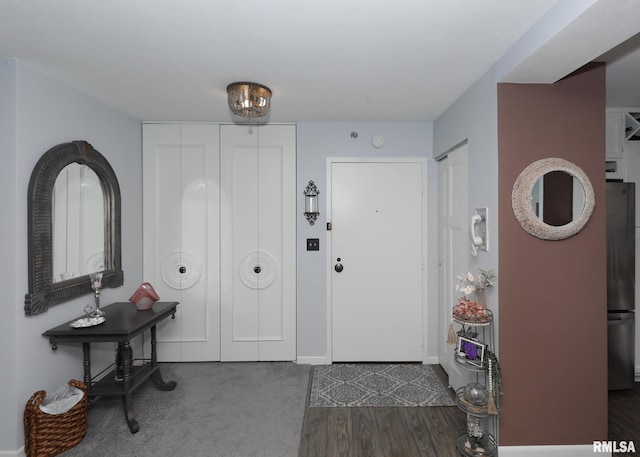 entryway featuring wood finished floors and baseboards