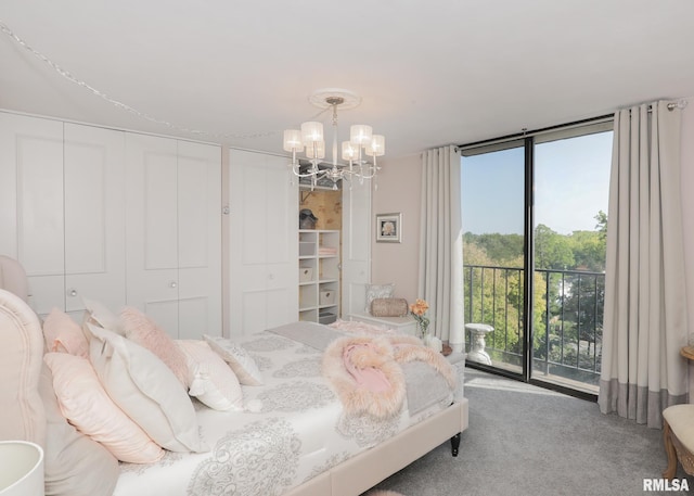 carpeted bedroom featuring an inviting chandelier and access to exterior