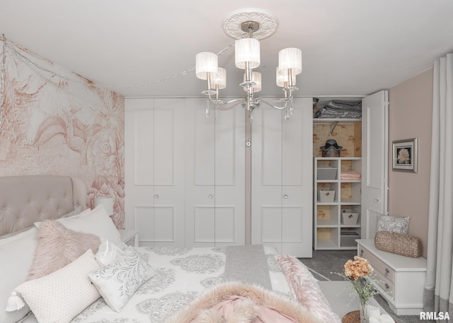 bedroom with an inviting chandelier and carpet flooring