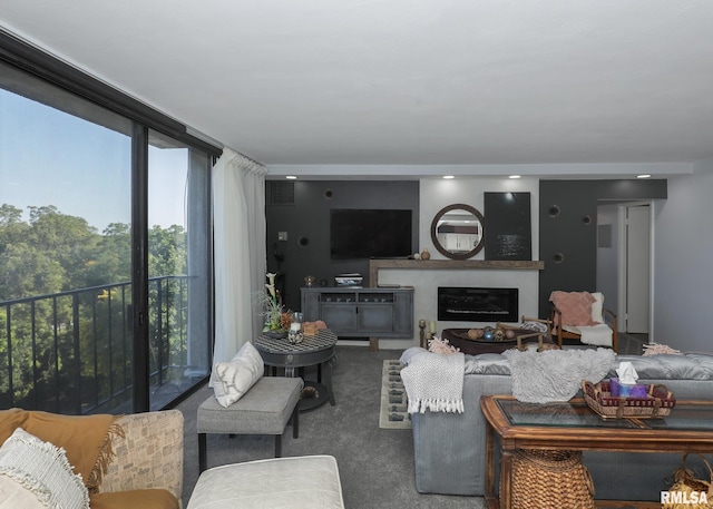 carpeted living room featuring a glass covered fireplace