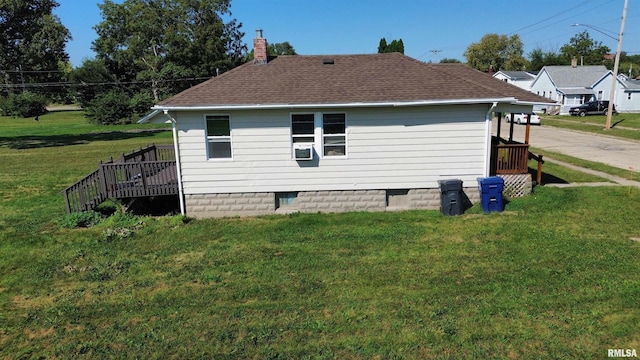 view of side of property featuring a shingled roof, crawl space, a lawn, a wooden deck, and a chimney