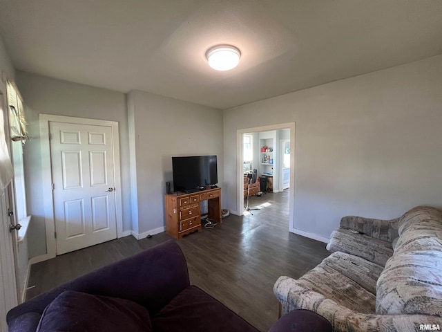 living room with dark wood-style flooring and baseboards