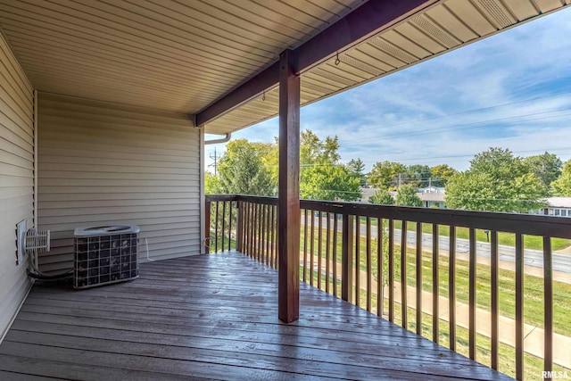 deck featuring a lawn and central air condition unit