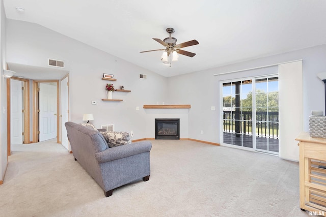 living room with vaulted ceiling, ceiling fan, and light colored carpet