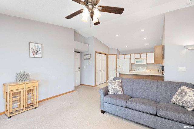 living room featuring vaulted ceiling, ceiling fan, and light colored carpet