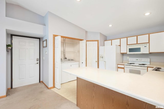 kitchen featuring independent washer and dryer, white appliances, kitchen peninsula, lofted ceiling, and light colored carpet