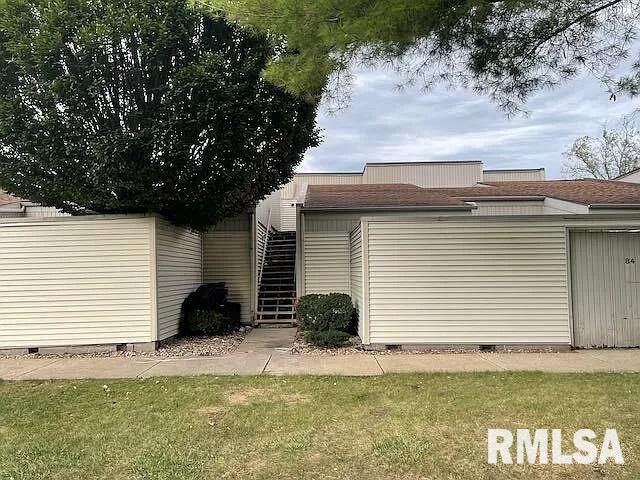 rear view of property with a yard