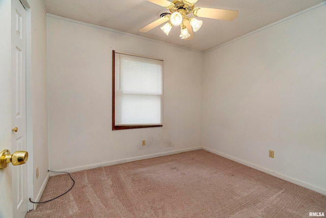 empty room with ornamental molding, light carpet, and ceiling fan