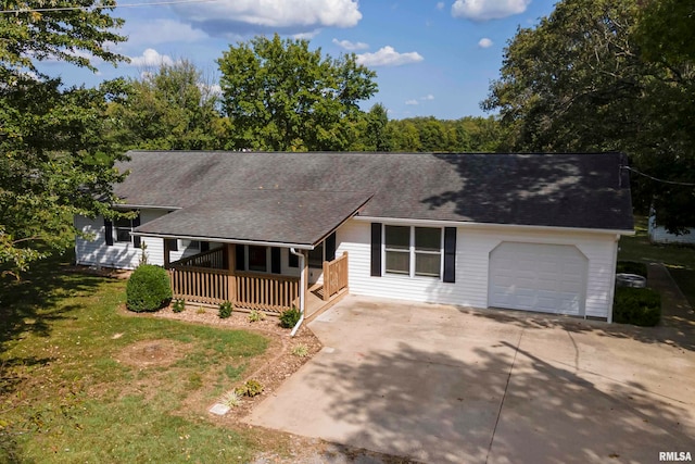 ranch-style home featuring covered porch, a garage, and a front lawn