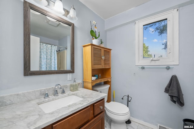 bathroom with vanity, toilet, and tile patterned floors