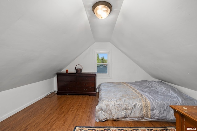 bedroom featuring lofted ceiling and hardwood / wood-style flooring