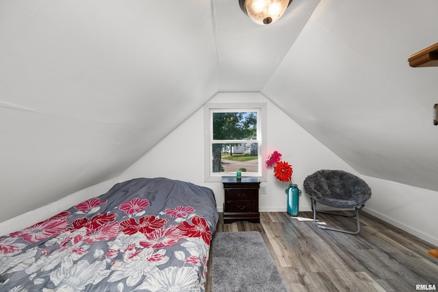 bedroom featuring vaulted ceiling and hardwood / wood-style flooring