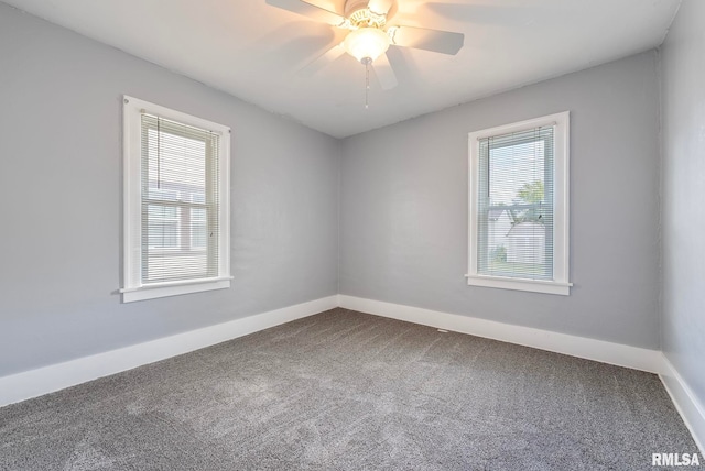 empty room featuring carpet, ceiling fan, and a wealth of natural light