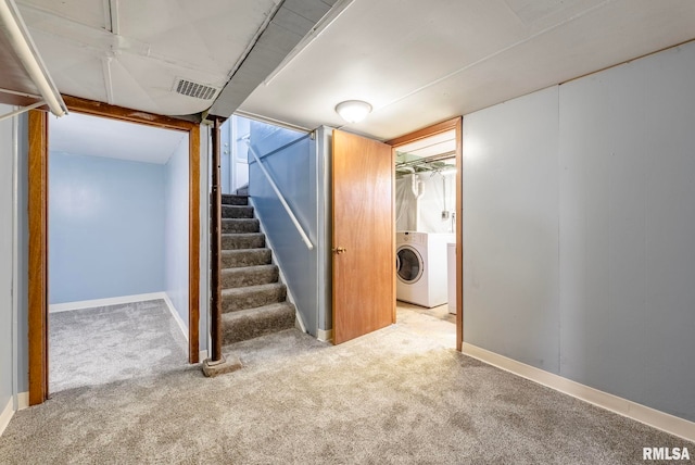 basement featuring carpet and washer / dryer