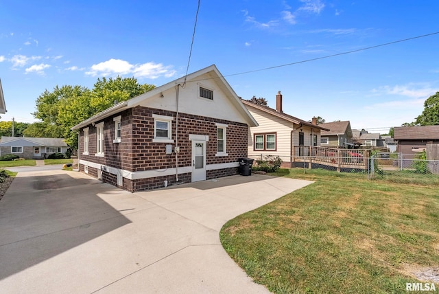 rear view of property with a yard