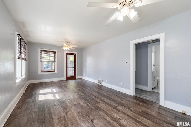 empty room featuring ceiling fan and dark wood-type flooring