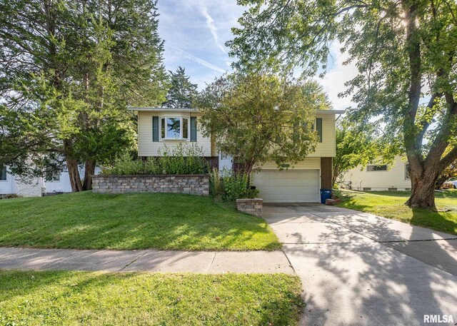 view of front facade with a front yard and a garage