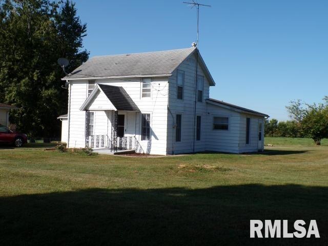 rear view of house with a yard