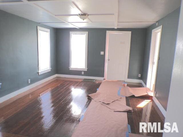 spare room with dark hardwood / wood-style flooring