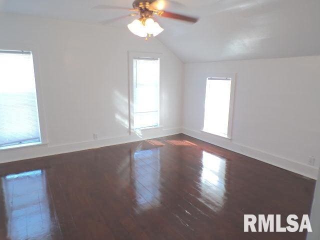 unfurnished room featuring ceiling fan, lofted ceiling, and dark wood-type flooring