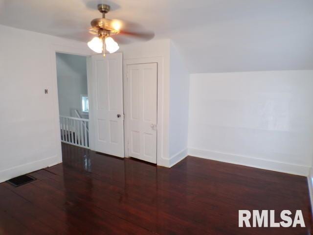 interior space with ceiling fan and dark hardwood / wood-style flooring