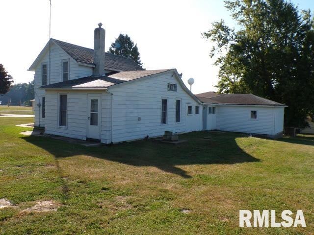 rear view of property with a yard