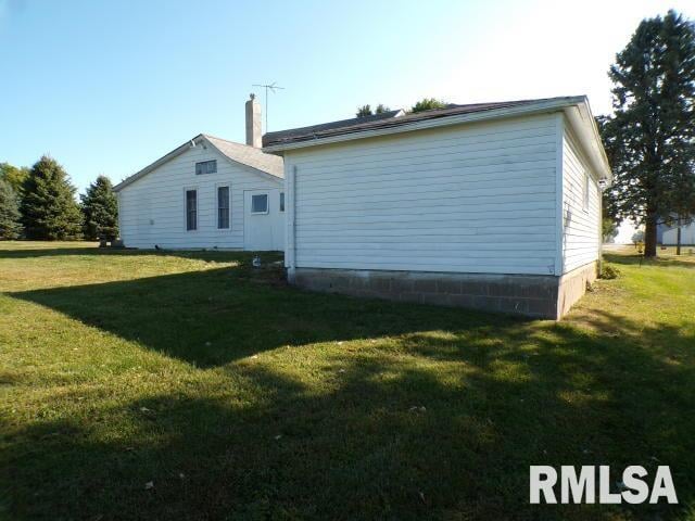 view of side of property with a yard