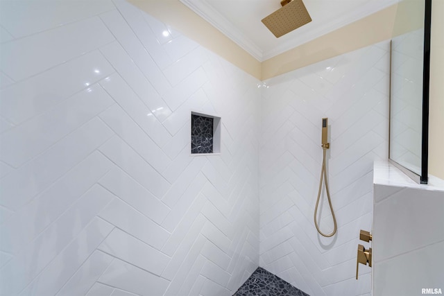 bathroom with a tile shower and ornamental molding