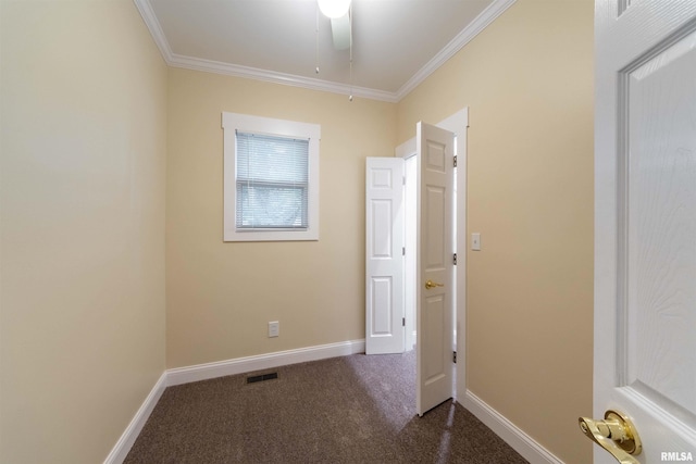 unfurnished bedroom featuring ornamental molding, dark carpet, and ceiling fan