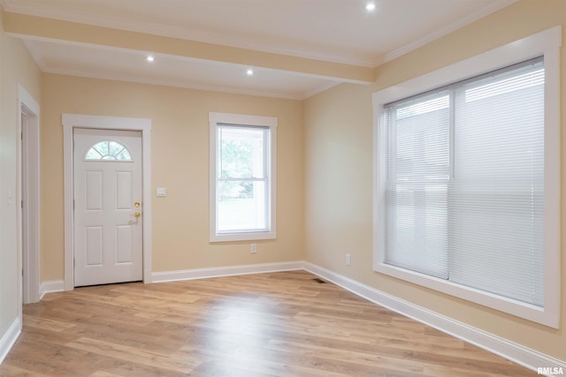 entrance foyer featuring light wood-type flooring and ornamental molding