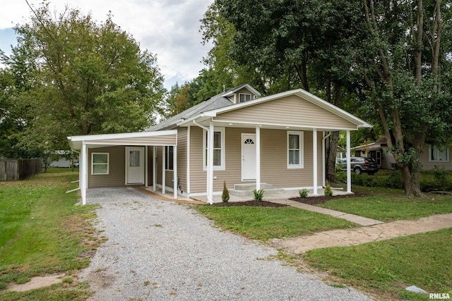 bungalow-style home featuring a front yard, a porch, and a carport