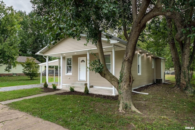 bungalow-style home with a front lawn and a porch