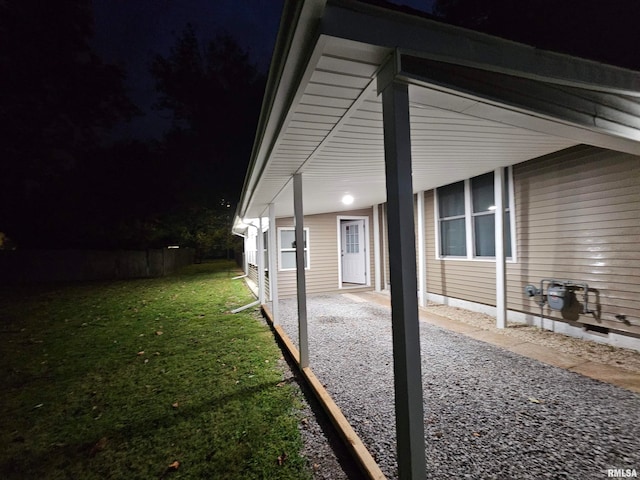 property exterior at twilight featuring a lawn