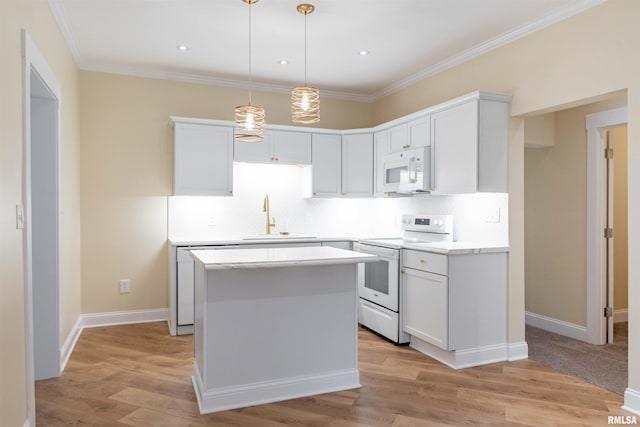 kitchen featuring white cabinetry, white appliances, a kitchen island, decorative light fixtures, and sink