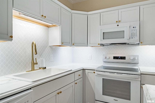 kitchen with decorative backsplash, electric range oven, dishwashing machine, and sink