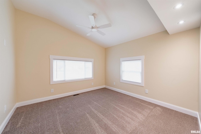 carpeted empty room with ceiling fan and vaulted ceiling