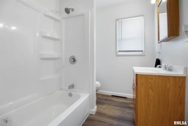 full bathroom featuring tub / shower combination, vanity, hardwood / wood-style floors, and toilet