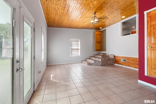 empty room featuring wooden ceiling, light tile patterned floors, and crown molding