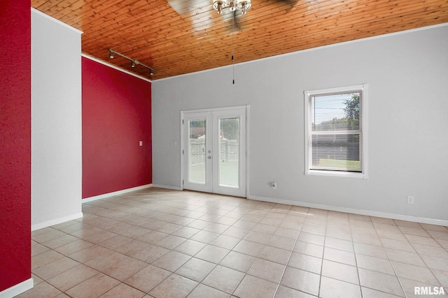 tiled empty room with wooden ceiling, rail lighting, french doors, and plenty of natural light