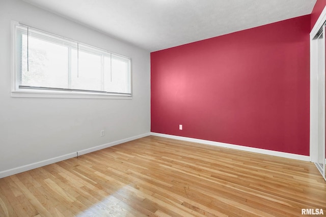 empty room with light hardwood / wood-style flooring