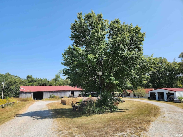 view of front facade featuring a front lawn and an outbuilding