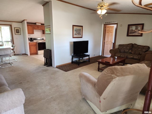 living room with crown molding, vaulted ceiling, light carpet, and ceiling fan