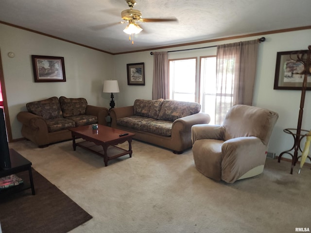 living room featuring a textured ceiling, ornamental molding, ceiling fan, and light colored carpet