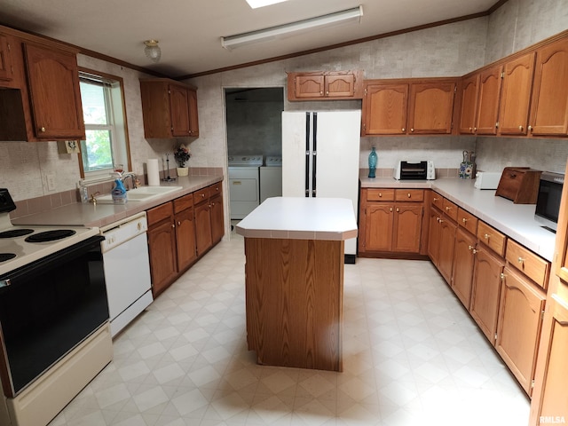 kitchen featuring white appliances, lofted ceiling, a kitchen island, and crown molding