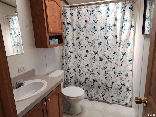 bathroom featuring walk in shower, vanity, and toilet