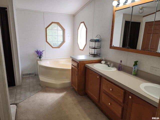 bathroom with ornamental molding, a bathing tub, and vanity