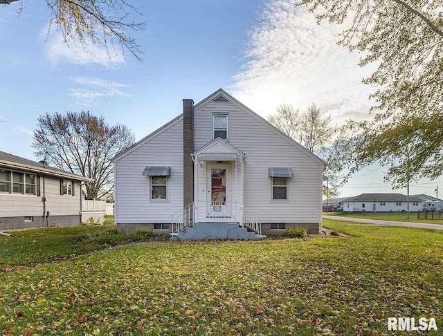 bungalow-style home with a front yard