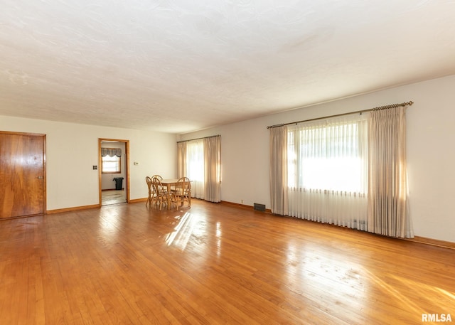 unfurnished room featuring a textured ceiling and hardwood / wood-style flooring