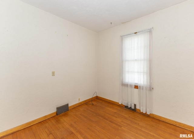 spare room with wood-type flooring